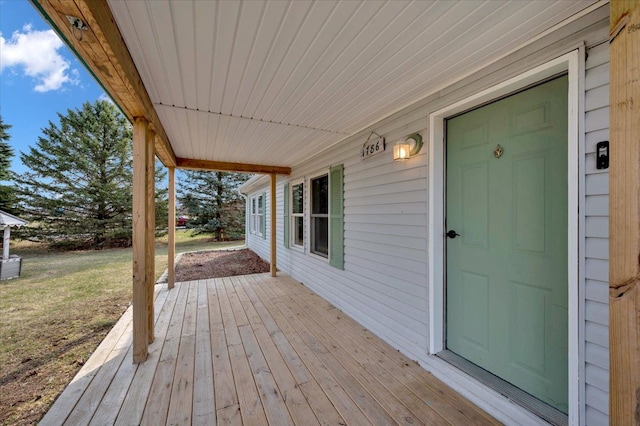 wooden terrace with a lawn