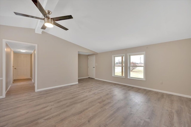 unfurnished living room featuring a ceiling fan, lofted ceiling with beams, baseboards, and light wood-type flooring