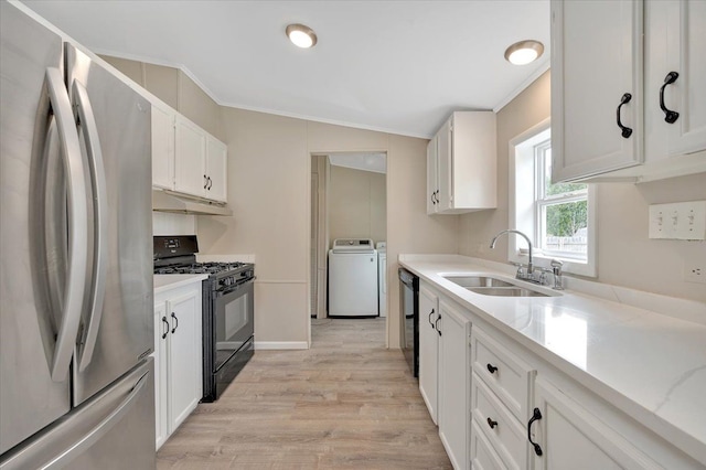 kitchen featuring a sink, white cabinets, under cabinet range hood, washer / dryer, and black appliances