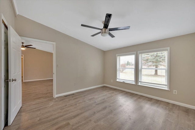 empty room with baseboards, light wood-style floors, and a ceiling fan