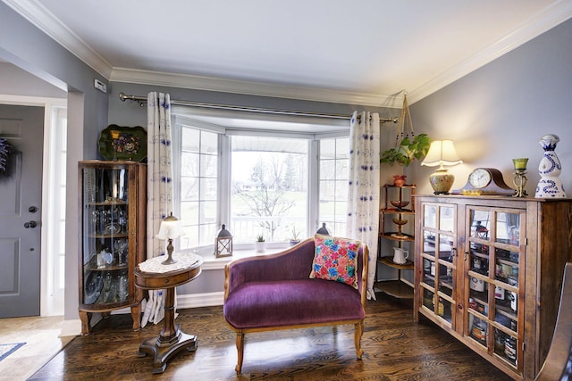 sitting room with crown molding, baseboards, and wood finished floors