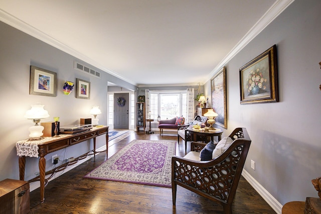 living area featuring baseboards, visible vents, crown molding, and wood finished floors