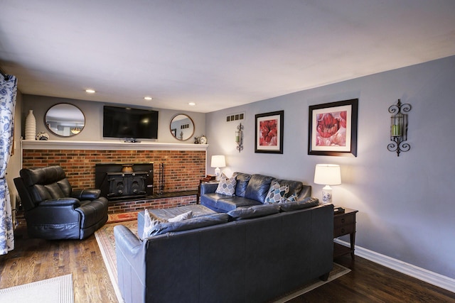 living room featuring wood finished floors, recessed lighting, baseboards, and visible vents