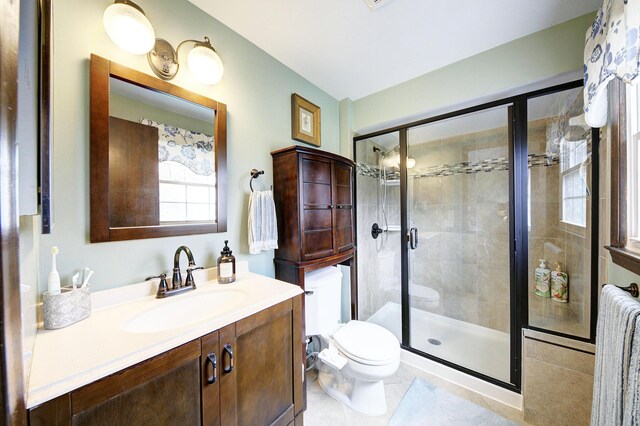 full bath featuring vanity, toilet, tile patterned flooring, and a shower stall