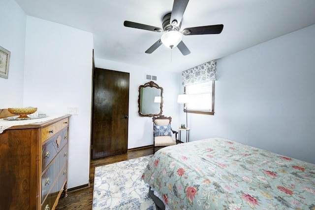 bedroom with dark wood finished floors, baseboards, visible vents, and ceiling fan