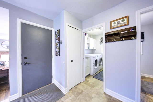 laundry area featuring cabinet space, baseboards, and washer and dryer