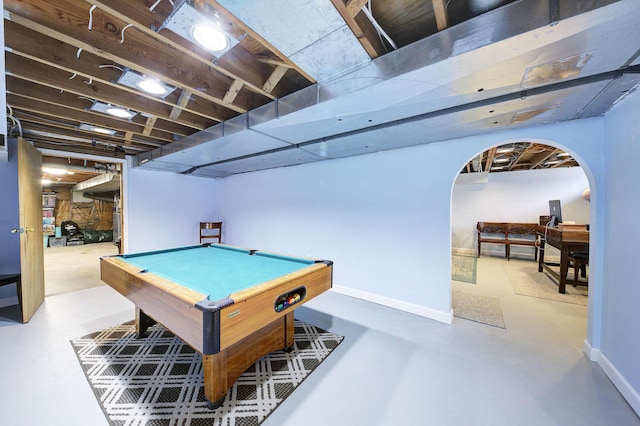 rec room featuring baseboards, arched walkways, concrete floors, and pool table