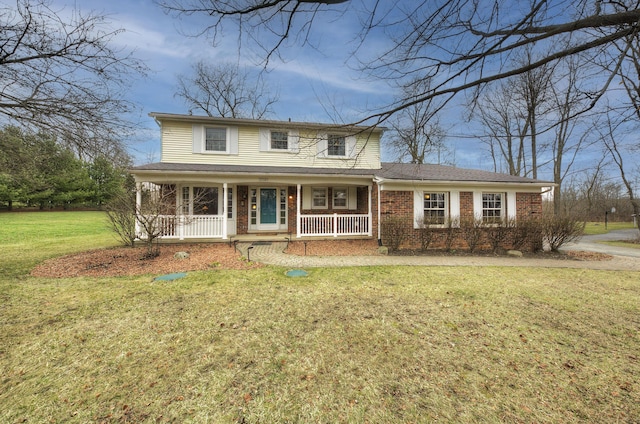 view of front of home featuring brick siding, a porch, and a front lawn