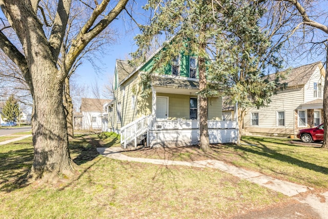 view of front of house featuring a front yard and covered porch