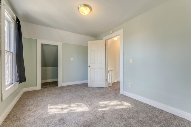 unfurnished bedroom with baseboards and carpet flooring