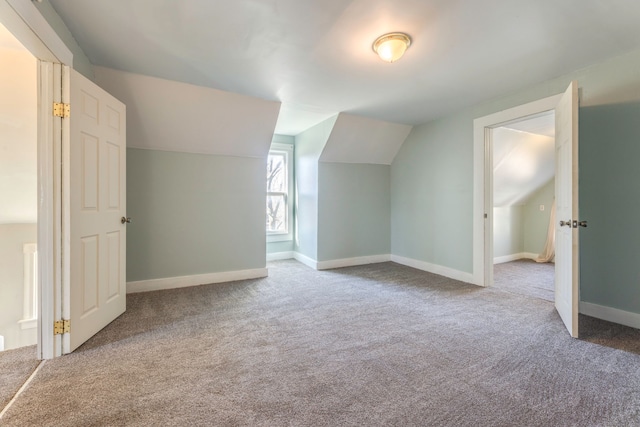 bonus room featuring vaulted ceiling, carpet floors, and baseboards