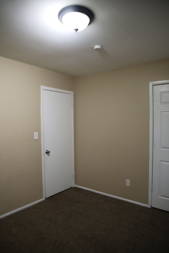 spare room with carpet floors and baseboards