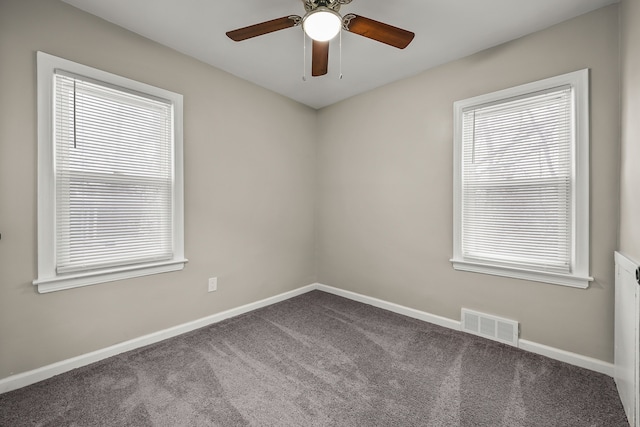 unfurnished room with visible vents, ceiling fan, carpet, and baseboards
