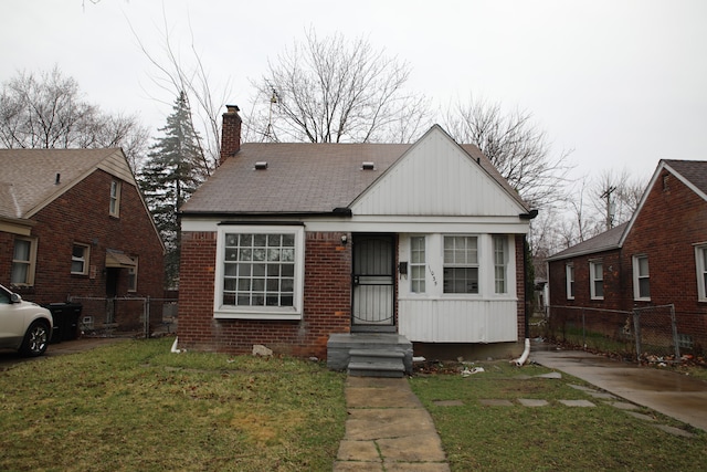 11035 Worden St, Detroit, MI 48224 - bungalow-style house with board and batten siding, a chimney, fence, and a front lawn