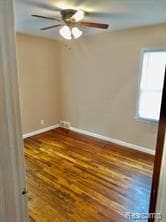 11035 Worden St, Detroit, MI 48224 - unfurnished room with baseboards, ceiling fan, and wood finished floors