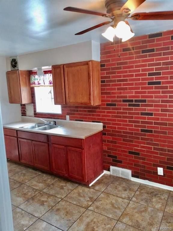 11035 Worden St, Detroit, MI 48224 - kitchen with light countertops, a sink, visible vents, a ceiling fan, and brown cabinetry