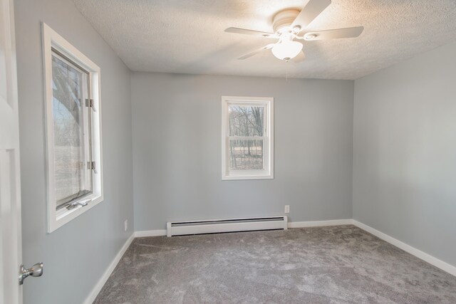 carpeted empty room with a ceiling fan, a textured ceiling, baseboards, and baseboard heating