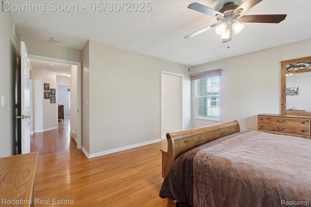 328 Split Rail Rdg, Williamston, MI 48895 - bedroom with light wood-type flooring, baseboards, a textured ceiling, and ceiling fan