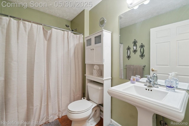 328 Split Rail Rdg, Williamston, MI 48895 - full bathroom featuring a textured ceiling, toilet, wood finished floors, a sink, and a shower with curtain