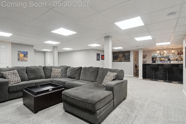 328 Split Rail Rdg, Williamston, MI 48895 - carpeted living room featuring a dry bar and a paneled ceiling