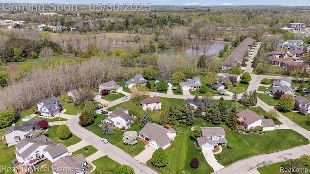 328 Split Rail Rdg, Williamston, MI 48895 - aerial view of property and surrounding area with nearby suburban area, a nearby body of water, and a heavily wooded area