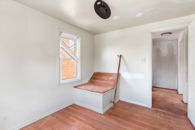 unfurnished bedroom with light wood-style flooring and baseboards