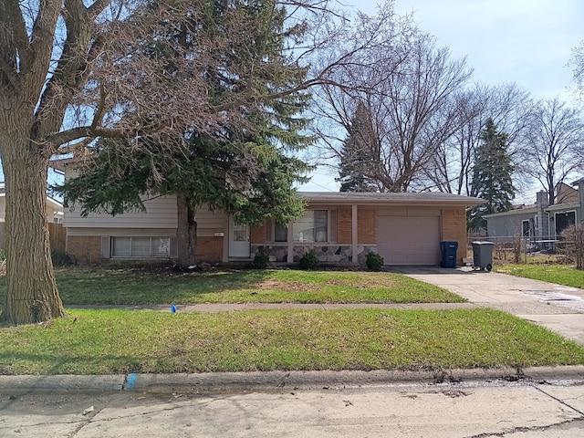 3508 Easthampton Dr, Flint, MI 48503 - view of front facade with brick siding, an attached garage, a front yard, and concrete driveway