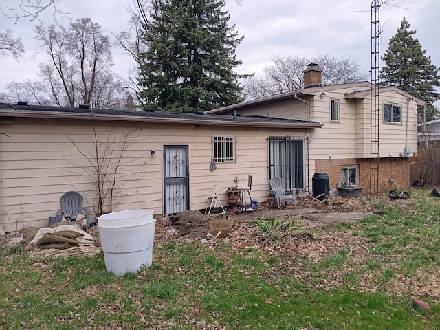 3508 Easthampton Dr, Flint, MI 48503 - rear view of house with a chimney and central AC unit