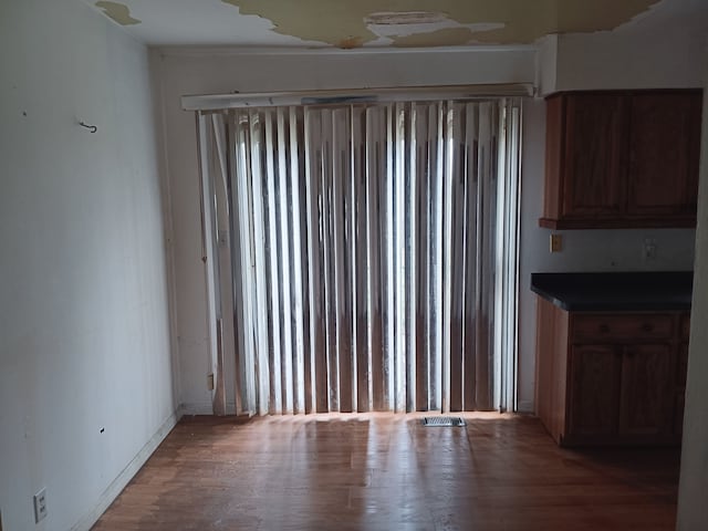 3508 Easthampton Dr, Flint, MI 48503 - unfurnished dining area featuring light wood-type flooring and visible vents