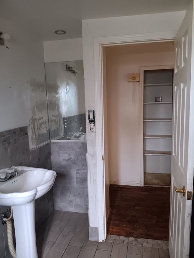 3508 Easthampton Dr, Flint, MI 48503 - bathroom featuring tile walls, a wainscoted wall, and wood finished floors