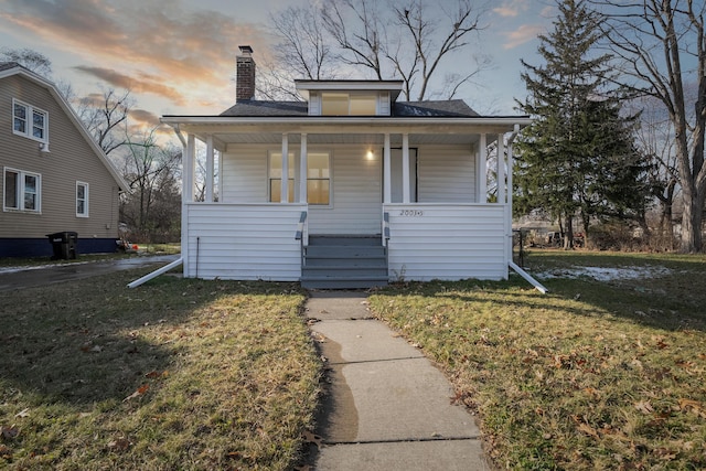 20035 Santa Barbara Dr, Detroit, MI 48221 - bungalow-style home featuring a chimney, covered porch, and a yard