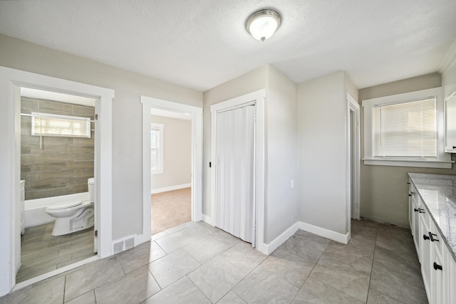 20035 Santa Barbara Dr, Detroit, MI 48221 - full bath featuring toilet, vanity, a textured ceiling, baseboards, and visible vents