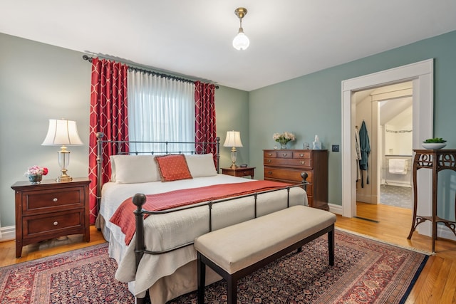 bedroom featuring baseboards and wood finished floors