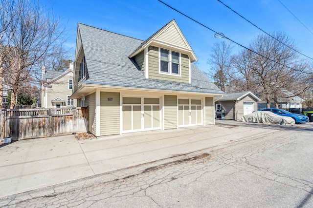 view of front of home featuring a shingled roof and fence