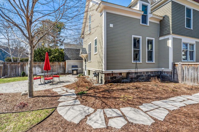 view of home's exterior featuring fence and a patio area