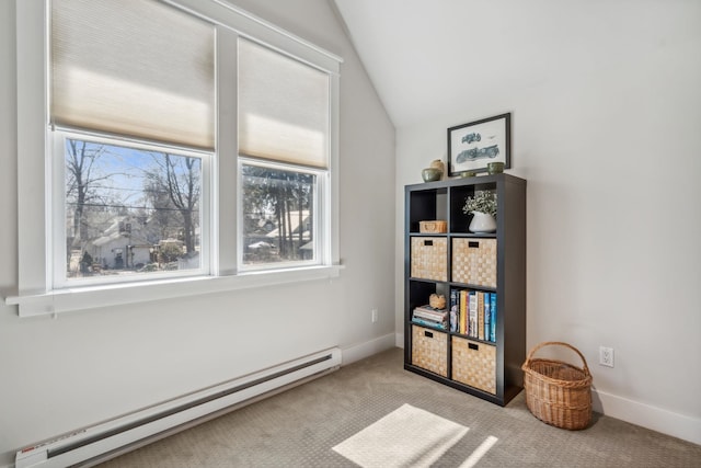 interior space with baseboards, vaulted ceiling, carpet, and a baseboard radiator