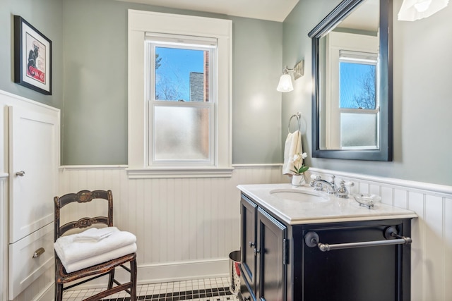 bathroom with a wainscoted wall and vanity