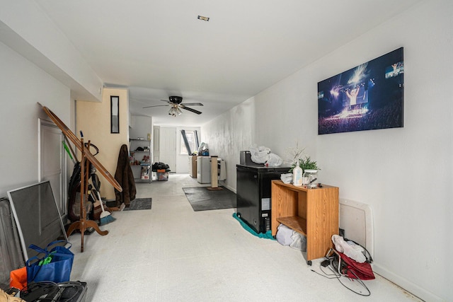 interior space featuring baseboards and ceiling fan