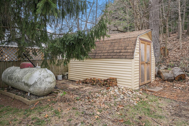 view of yard with an outdoor structure, fence, and a storage shed
