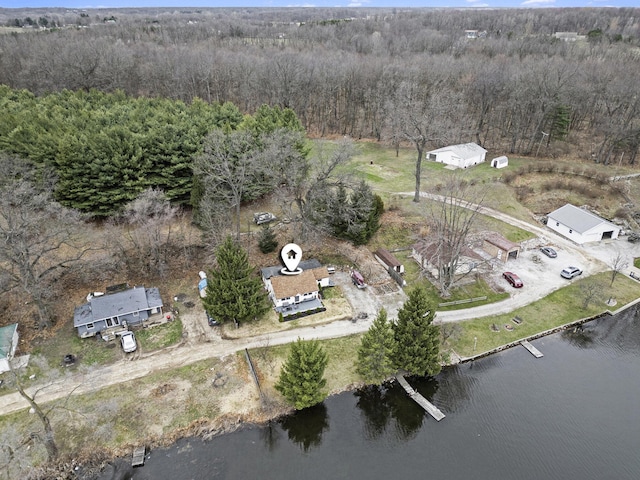 birds eye view of property featuring a water view and a forest view