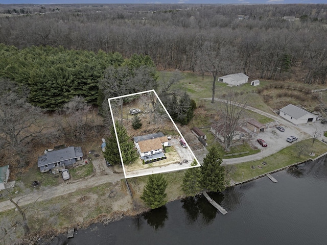 bird's eye view featuring a wooded view and a water view