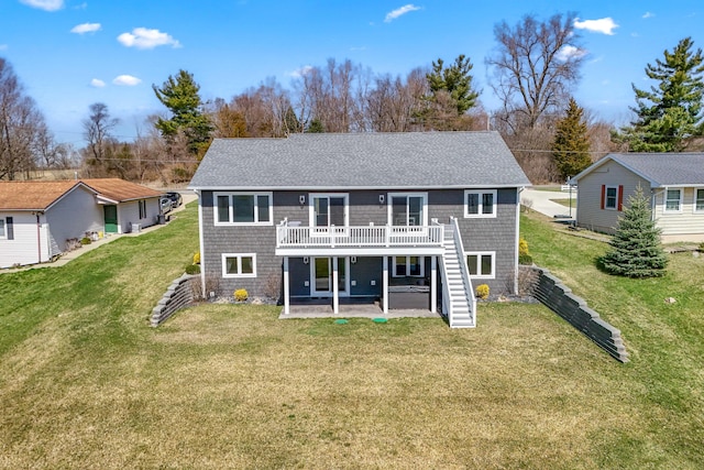rear view of property featuring a lawn, stairs, a wooden deck, and a patio area