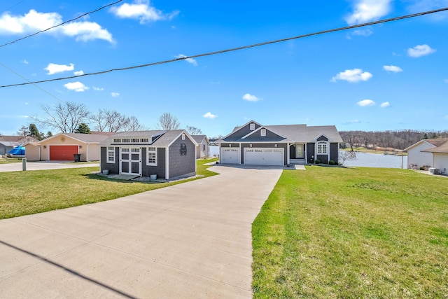 ranch-style home featuring driveway, a front yard, a water view, and an attached garage