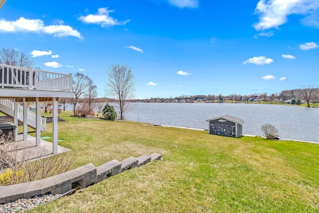 view of yard featuring a deck with water view and stairway