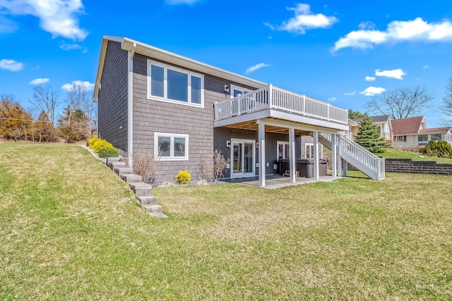 rear view of property with stairs, a wooden deck, a patio, and a yard