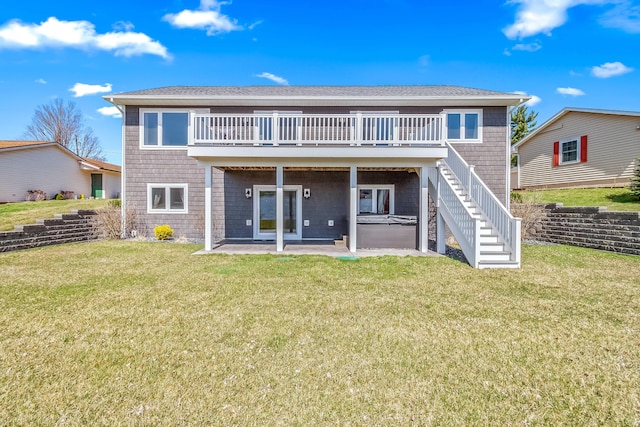 rear view of house with stairs, a wooden deck, a patio, and a lawn