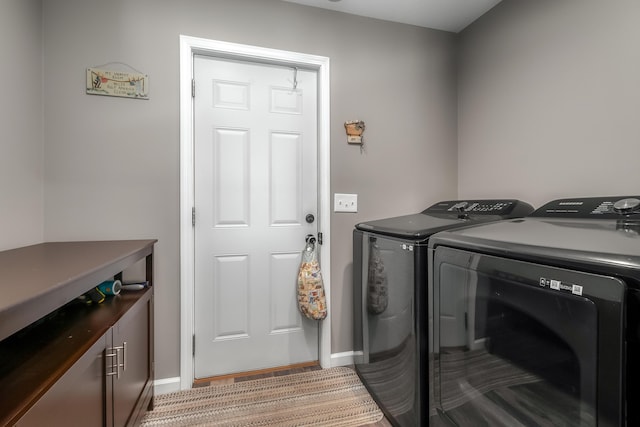 washroom with separate washer and dryer, baseboards, and laundry area