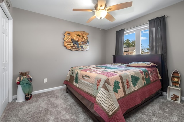 carpeted bedroom featuring a closet, ceiling fan, and baseboards