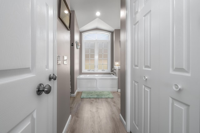 doorway to outside with baseboards and wood finished floors