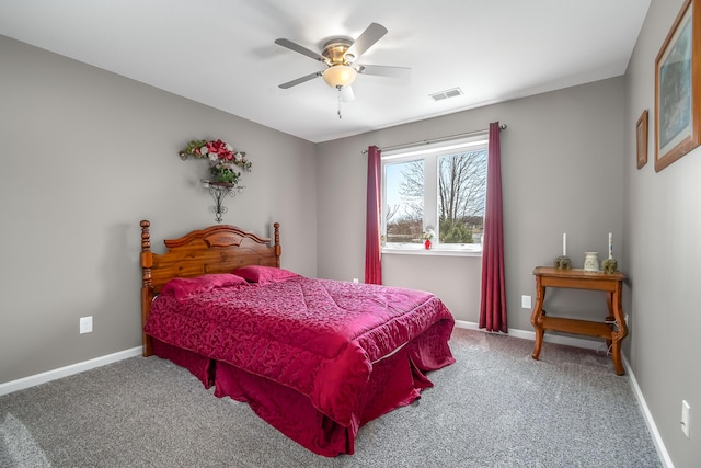 carpeted bedroom with a ceiling fan, baseboards, and visible vents